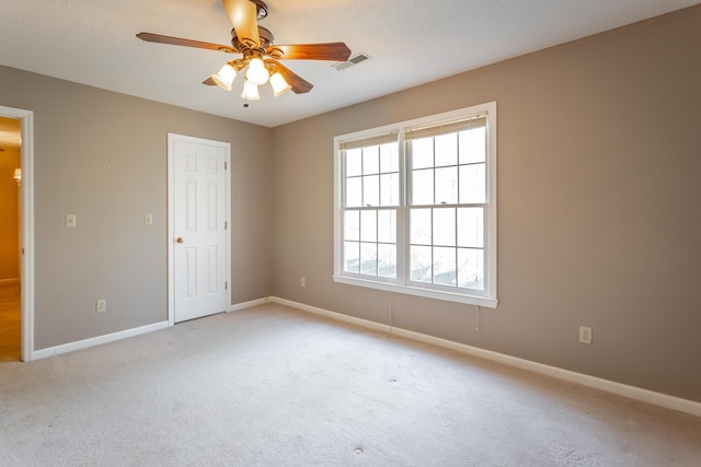 carpeted empty room with ceiling fan