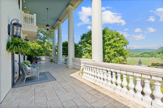 view of patio featuring a mountain view and covered porch