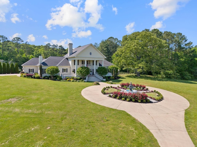 neoclassical / greek revival house with a front lawn and covered porch