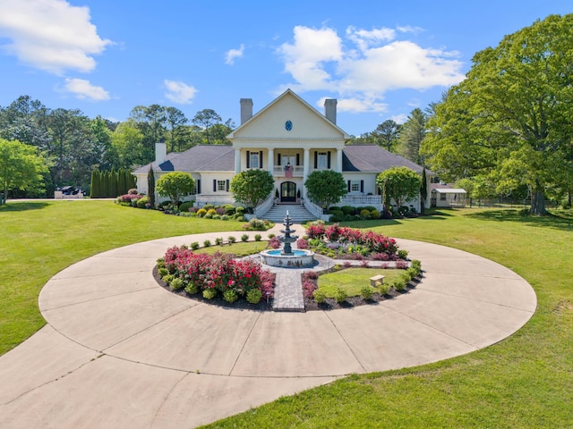 view of front of house with a front yard and covered porch