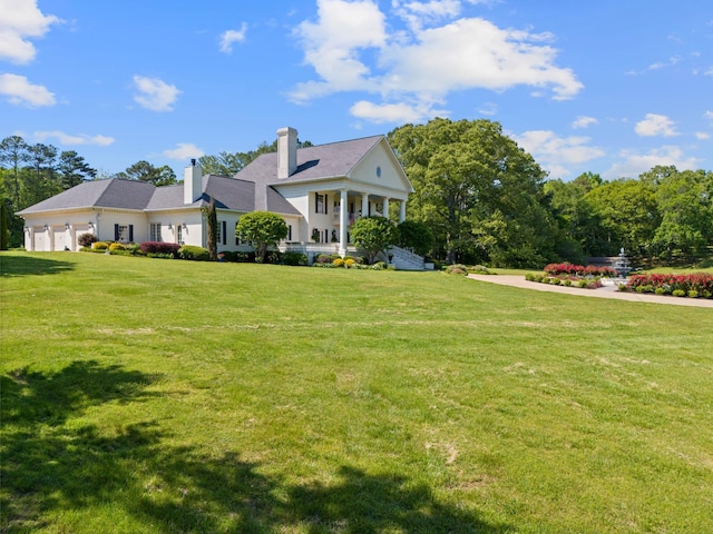 view of front of home with a garage and a front yard