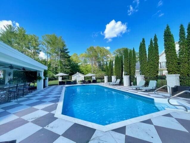 view of pool featuring a patio and an outdoor bar