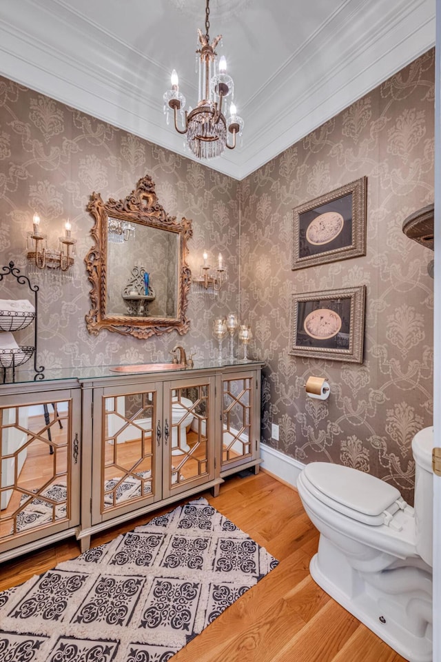 bathroom featuring hardwood / wood-style floors, toilet, and crown molding