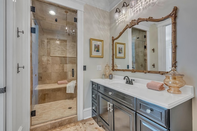 bathroom featuring ornamental molding, vanity, and a shower with shower door