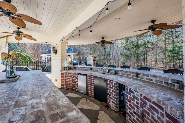 view of patio / terrace with area for grilling and an outdoor wet bar