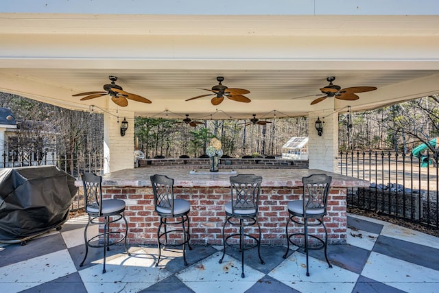 view of patio with grilling area and a bar