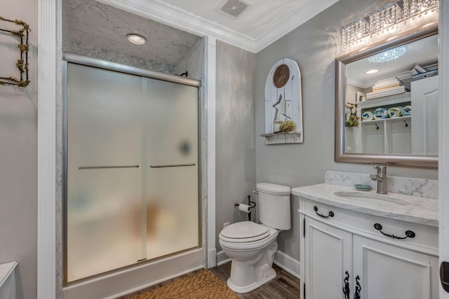 bathroom with hardwood / wood-style floors, vanity, an enclosed shower, crown molding, and toilet