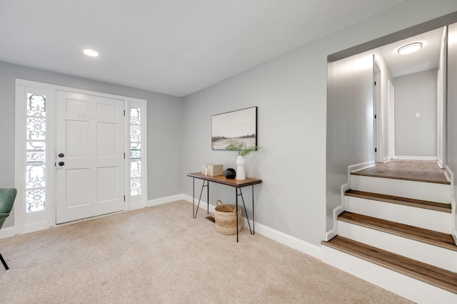 foyer entrance with light carpet