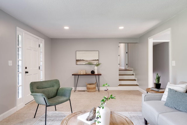 carpeted living room featuring a textured ceiling