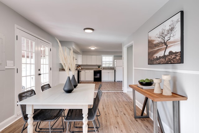 dining room featuring french doors and light hardwood / wood-style flooring