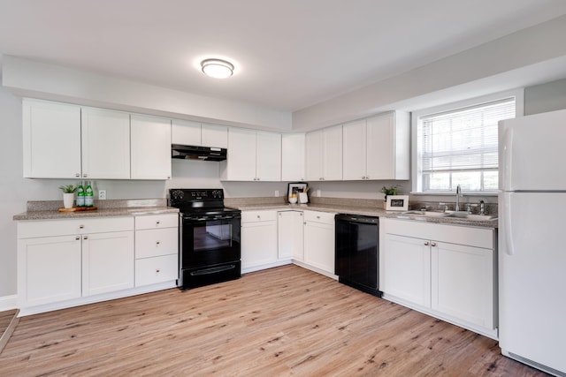 kitchen featuring light wood-type flooring, white cabinetry, and black appliances