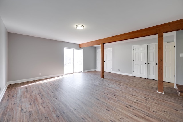 interior space featuring hardwood / wood-style flooring and multiple closets