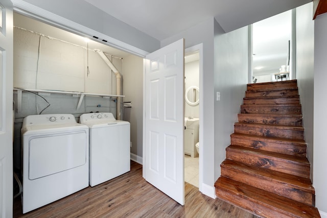 laundry room with light hardwood / wood-style floors and independent washer and dryer