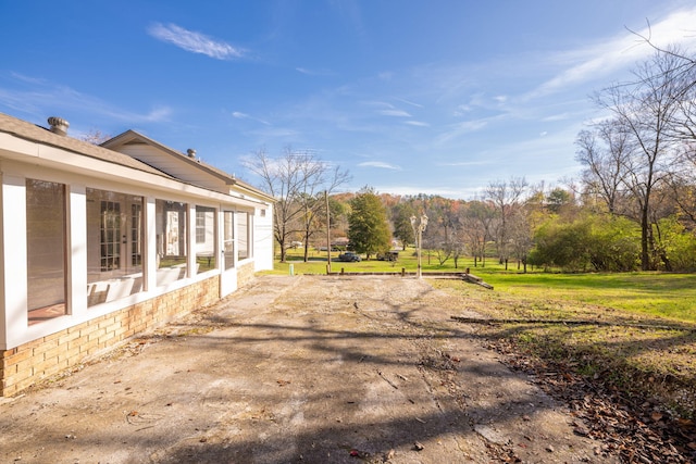 view of yard featuring a sunroom