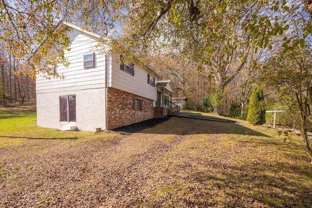 view of side of home featuring a yard