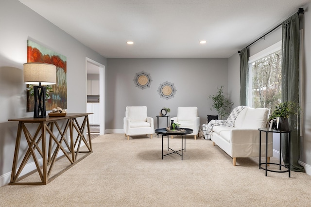 sitting room with light carpet, baseboards, and recessed lighting