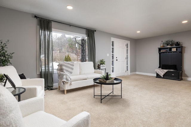 living area featuring light carpet, baseboards, and recessed lighting