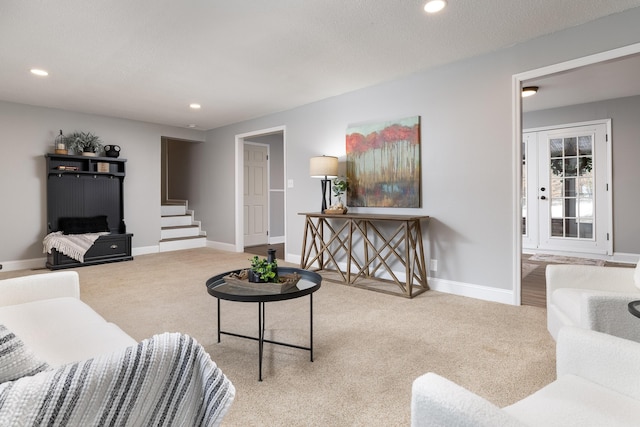 carpeted living area with stairway, baseboards, and recessed lighting