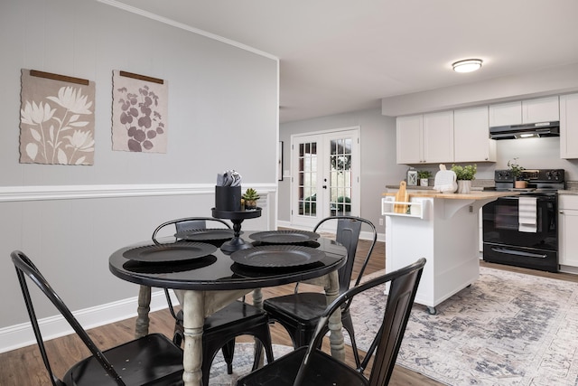 dining area with french doors, wood finished floors, and baseboards