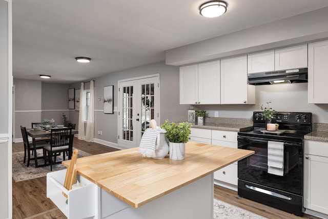 kitchen featuring black electric range, french doors, white cabinets, and under cabinet range hood