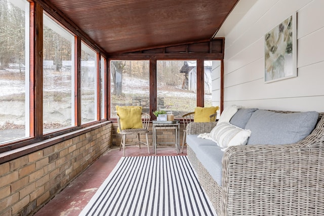 sunroom with vaulted ceiling, wooden ceiling, and plenty of natural light