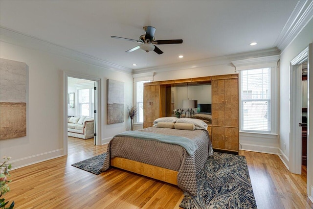 bedroom with ceiling fan, light wood-type flooring, and ornamental molding