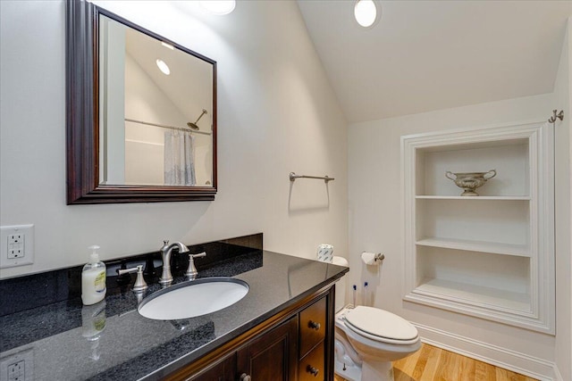 bathroom featuring a shower with shower curtain, vanity, hardwood / wood-style floors, toilet, and lofted ceiling