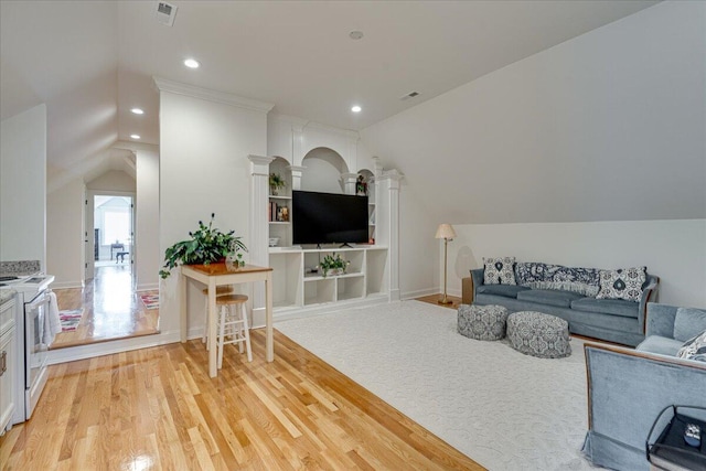 living room featuring light hardwood / wood-style floors and lofted ceiling