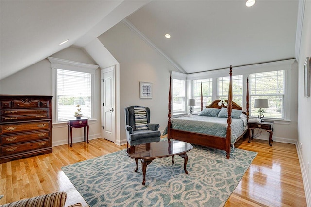 bedroom featuring multiple windows, vaulted ceiling, and light wood-type flooring