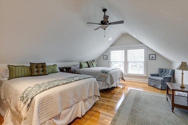 bedroom with light hardwood / wood-style floors, vaulted ceiling, and ceiling fan