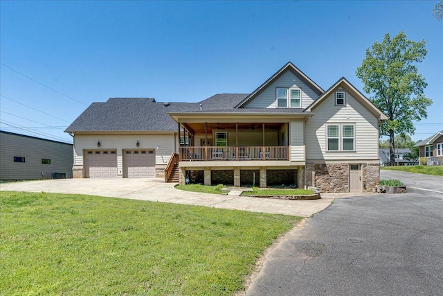 craftsman-style house featuring a porch, a front yard, and a garage