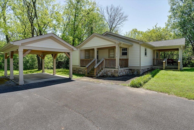 view of front of property with a porch, a carport, and a front lawn