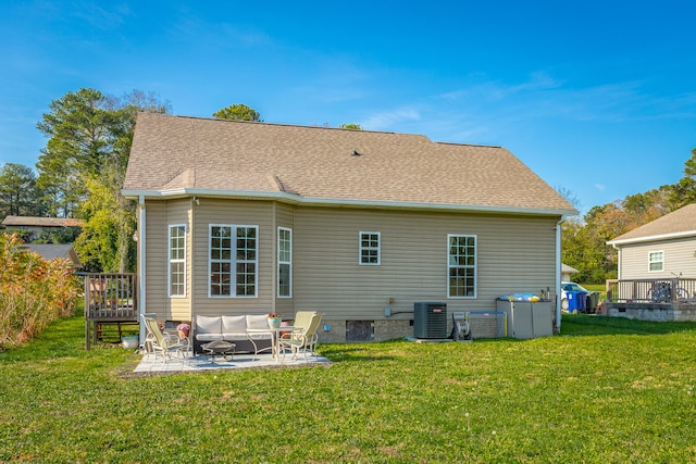 rear view of house with a lawn, outdoor lounge area, a patio, and central AC