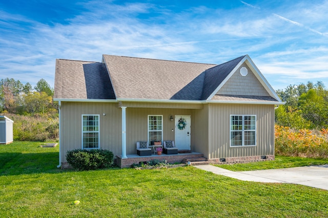 view of front of house with a porch and a front yard