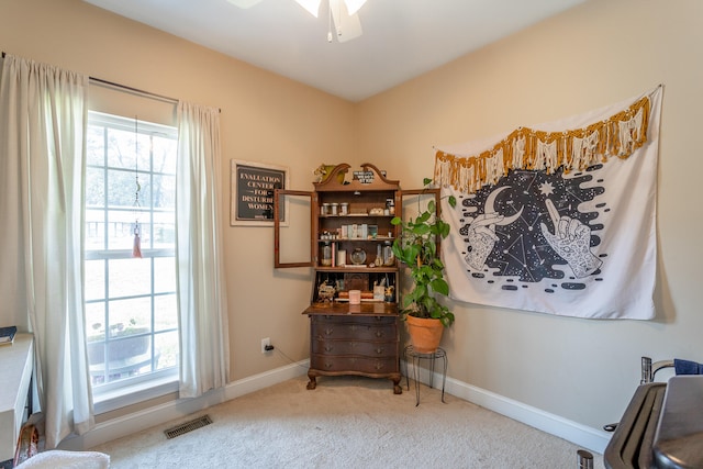 sitting room featuring ceiling fan and carpet floors