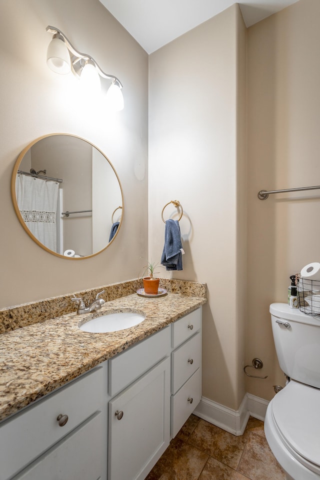 bathroom featuring tile patterned floors, vanity, and toilet