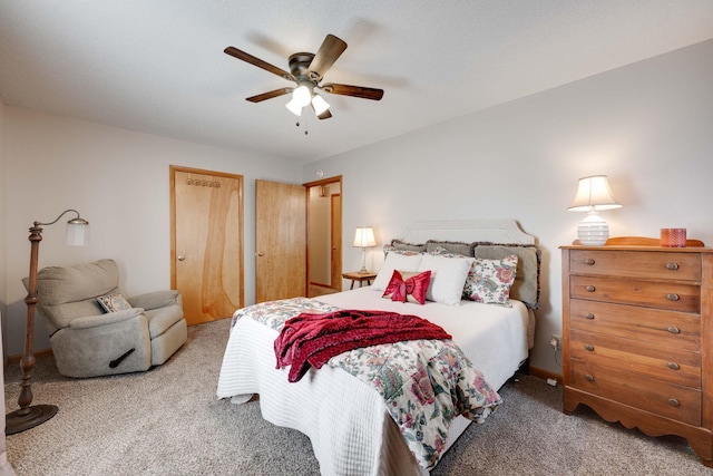 bedroom featuring ceiling fan, two closets, and carpet flooring