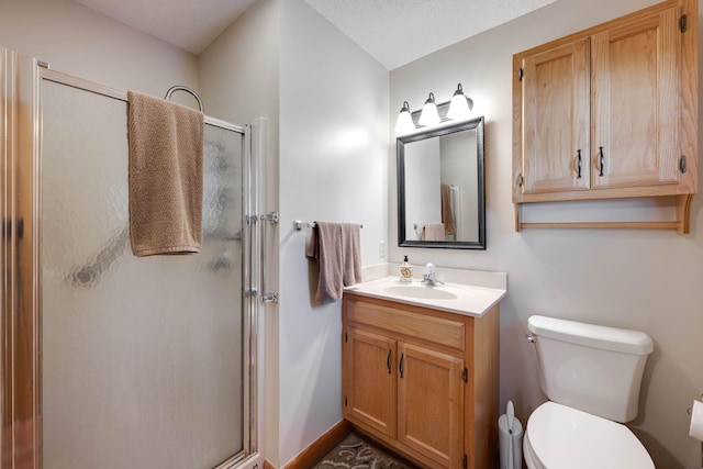 bathroom featuring a textured ceiling, walk in shower, vanity, and toilet