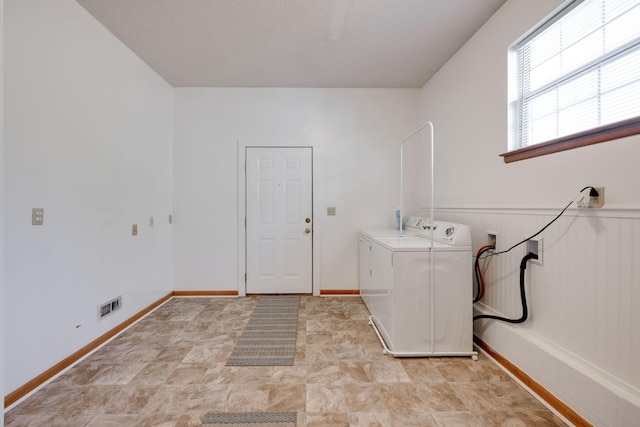 clothes washing area featuring independent washer and dryer