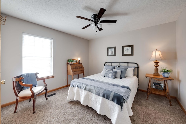 bedroom featuring a textured ceiling, ceiling fan, and carpet