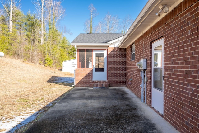 view of patio featuring a sunroom