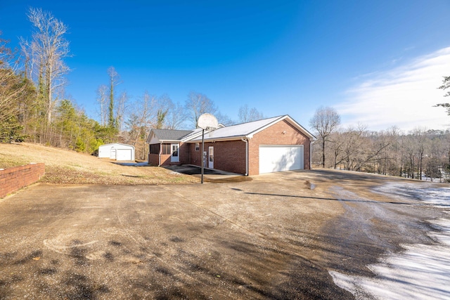 view of property exterior with a garage and a shed