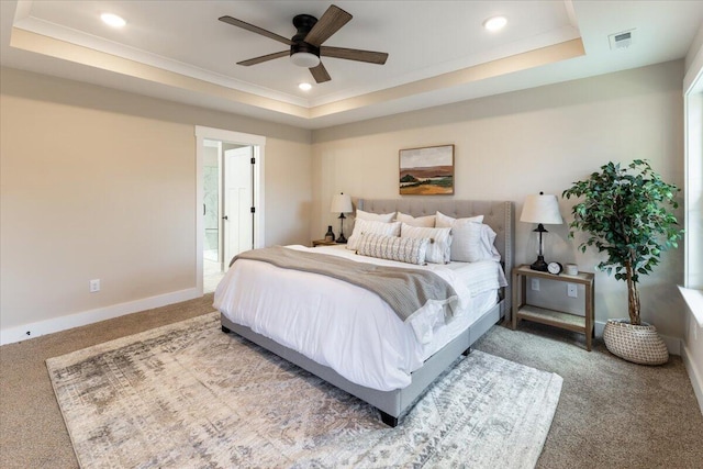 bedroom featuring carpet flooring, ceiling fan, and a raised ceiling