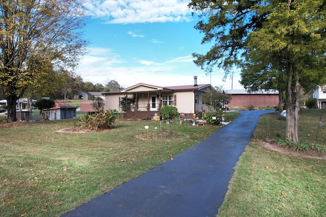 single story home with a porch and a front yard