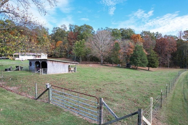 view of yard with an outbuilding and a rural view