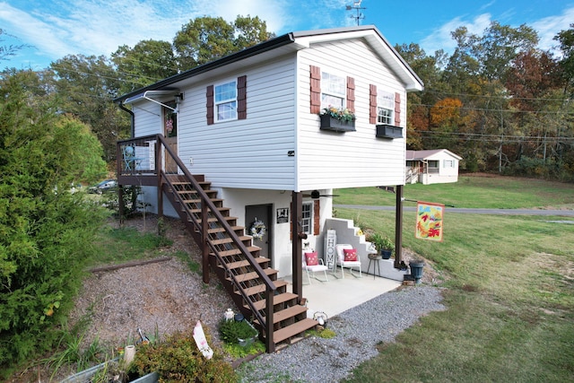 back of property with a patio and a yard