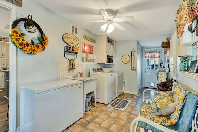 washroom with cabinets, ceiling fan, and independent washer and dryer