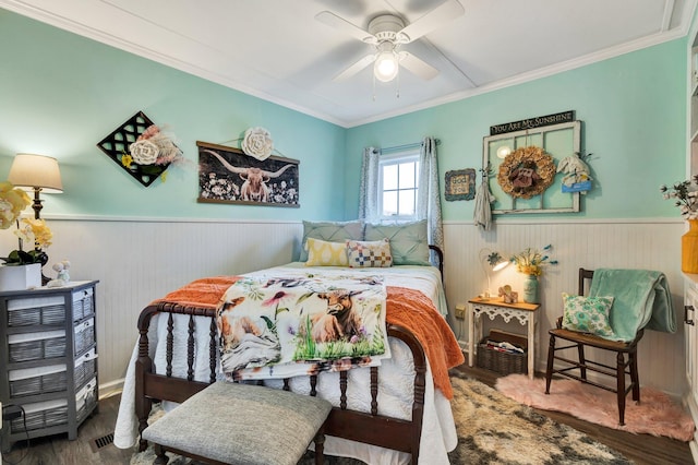 bedroom with ornamental molding, hardwood / wood-style floors, and ceiling fan