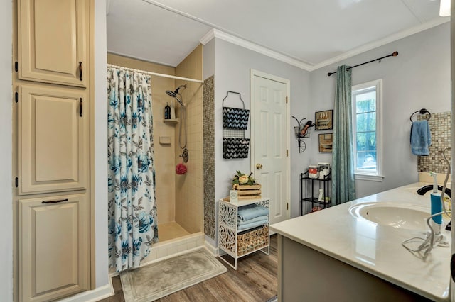 bathroom featuring hardwood / wood-style floors, walk in shower, vanity, and crown molding