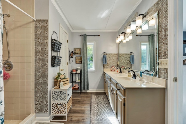 bathroom with vanity, hardwood / wood-style flooring, plenty of natural light, and crown molding